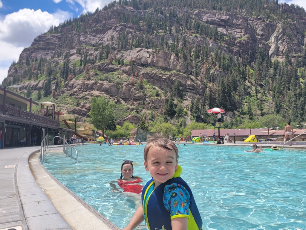 cooper and i at the hot springs with a mountain in the background