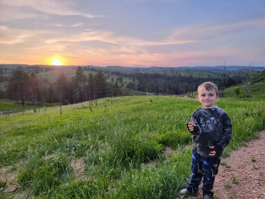 cooper in front of the sunset on the custer state park wildlife loop