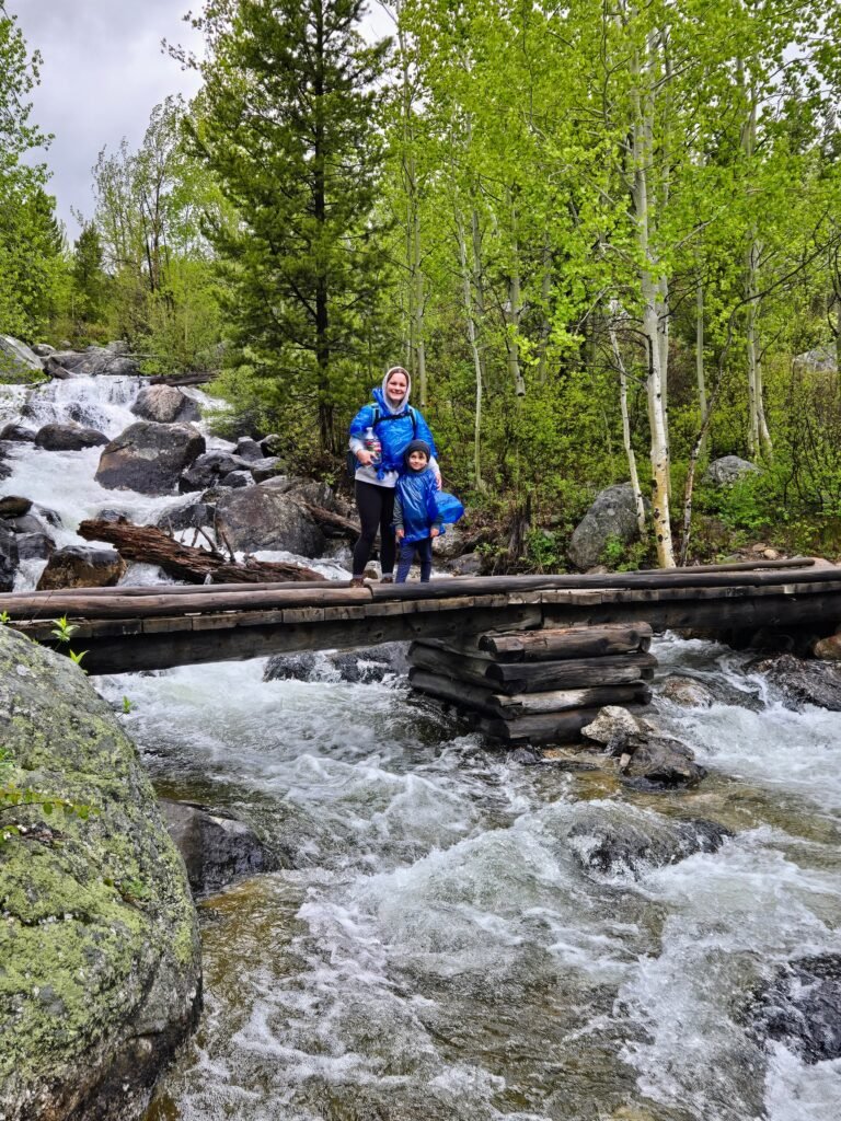 Cooper and I wearing ponchos and hiking in the rain