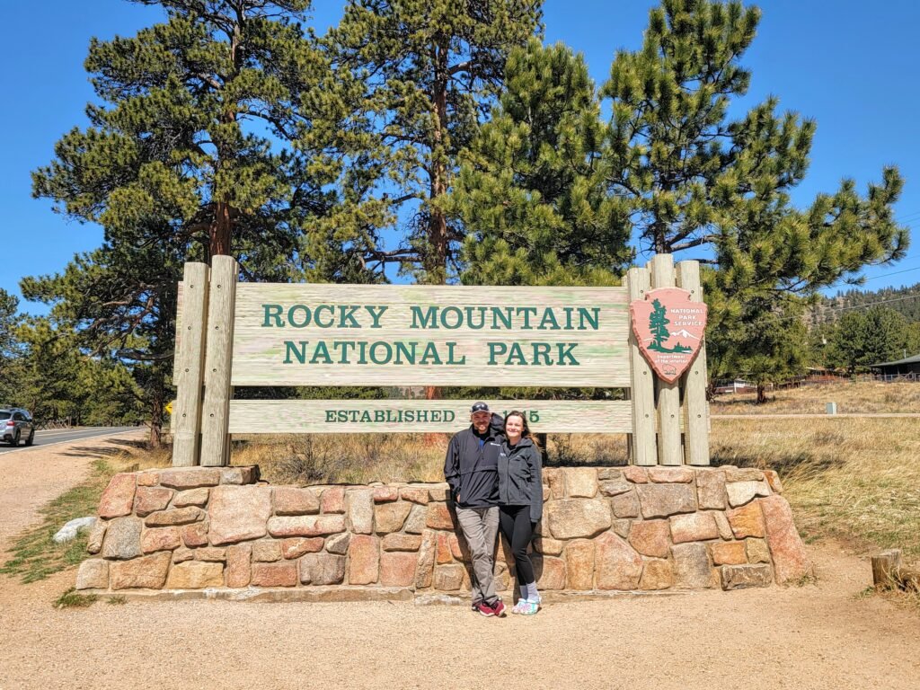 hunter and i in front of the rocky mountain national park sign